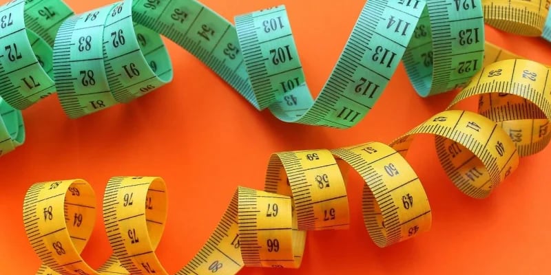 Ancient measurement tools transitioning to modern scientific instruments showing Egyptian cubit rod, medieval balance scales, and modern digital calipers